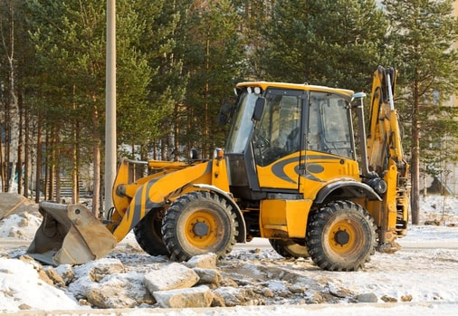 A loader is parked at a job site after being used to clear the land for construction.